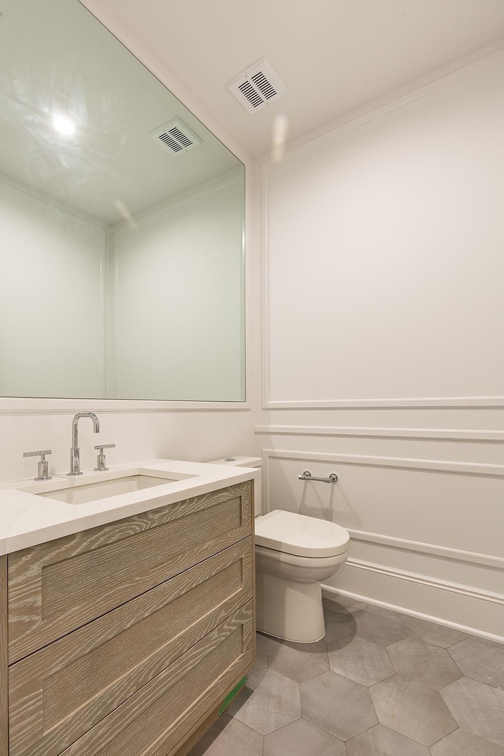 206 8th Street Hoboken, NJ 07030 - Photo 15 of 35 a bathroom with a granite countertop toilet a sink and a mirror
