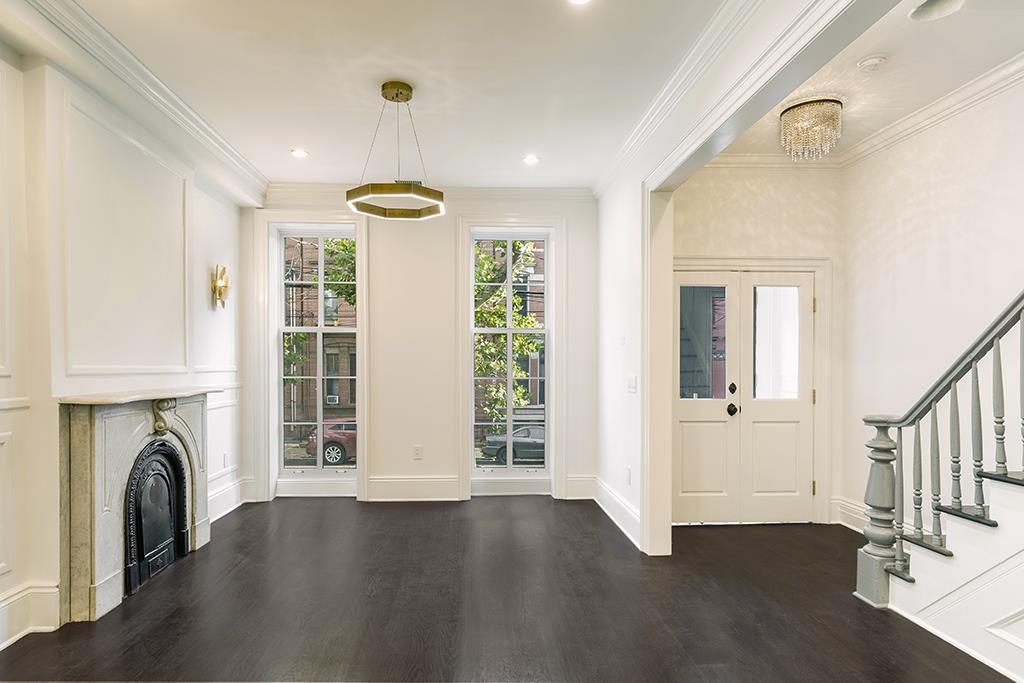 206 8th Street Hoboken, NJ 07030 - Photo 16 of 35 a view of a livingroom with a fireplace and a window