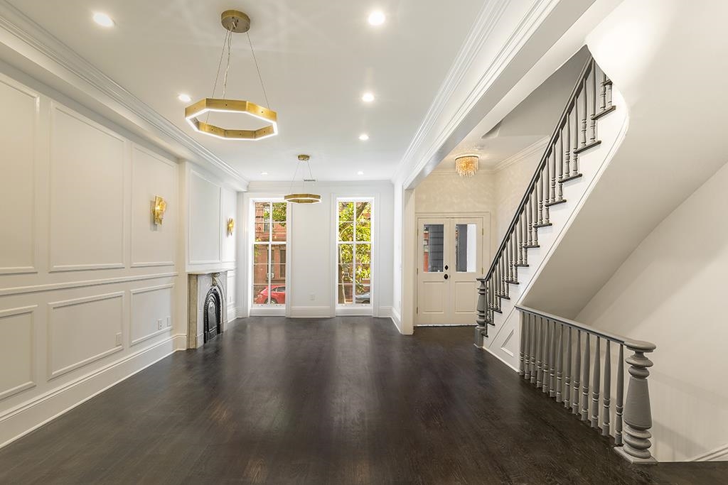 206 8th Street Hoboken, NJ 07030 - Photo 17 of 35 a view of an empty room with wooden floor and windows