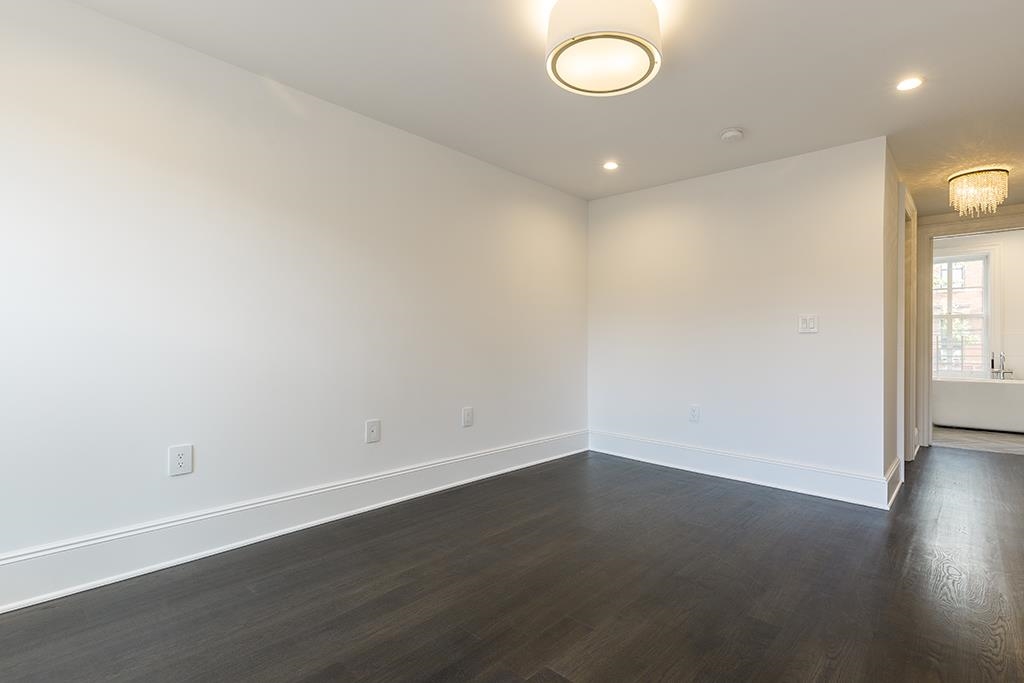 206 8th Street Hoboken, NJ 07030 - Photo 19 of 35 an empty room with wooden floor and windows