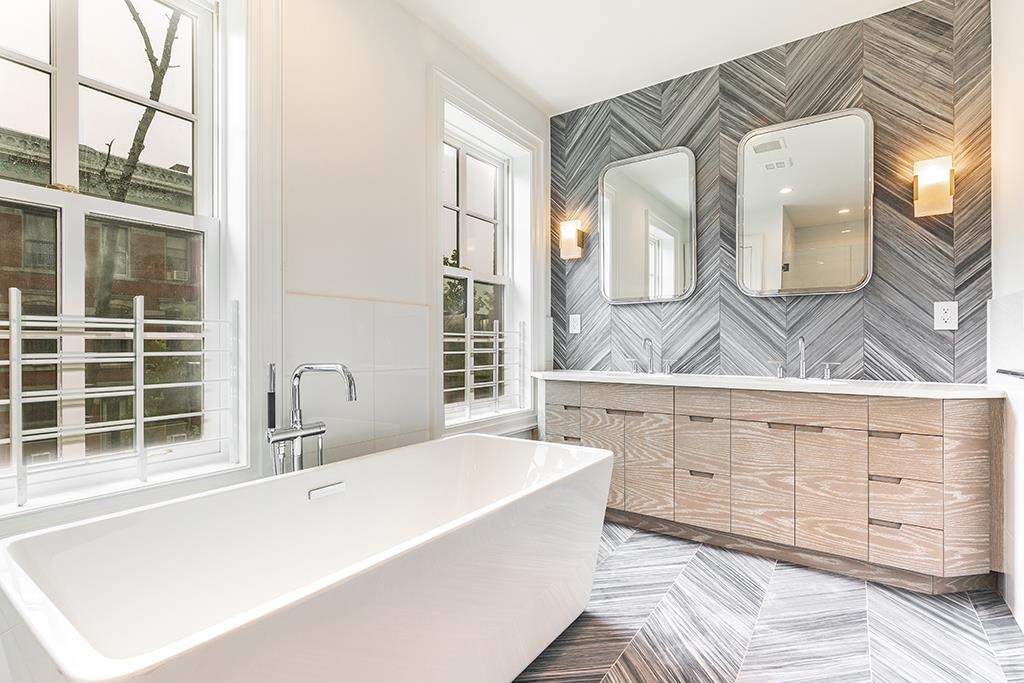 206 8th Street Hoboken, NJ 07030 - Photo 25 of 35 a spacious bathroom with a tub a double vanity sink a mirror and a shower