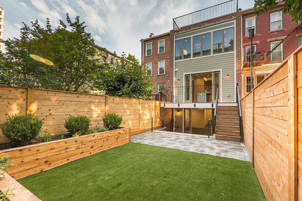 206 8th Street Hoboken, NJ 07030 - Photo 34 of 35 a view of house with backyard and garden