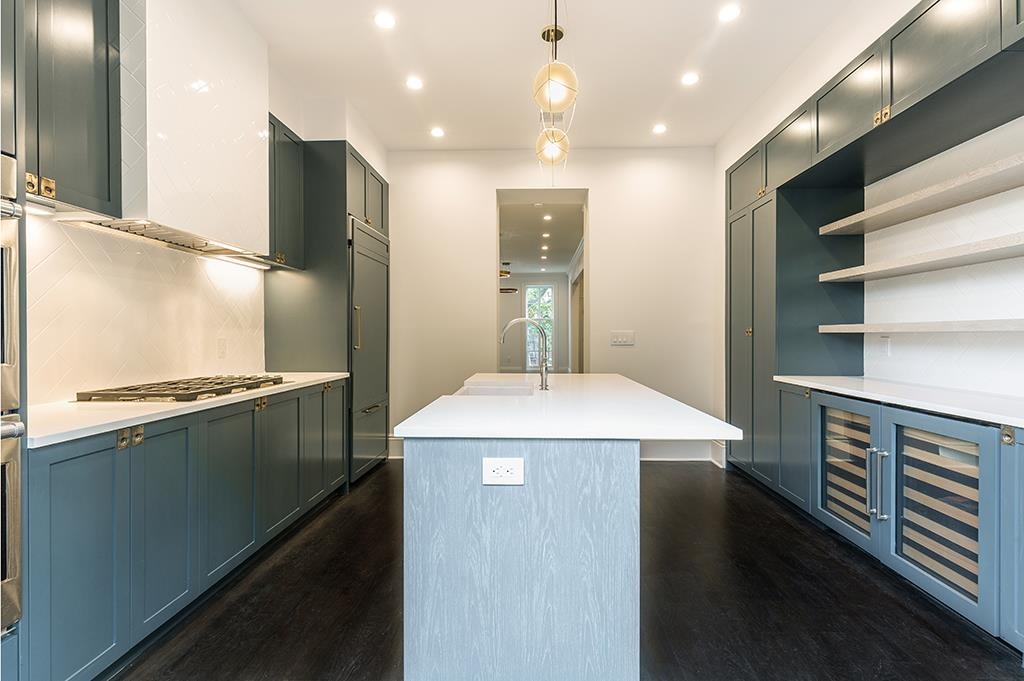 206 8th Street Hoboken, NJ 07030 - Photo 4 of 35 a kitchen with kitchen island a sink appliances and cabinets