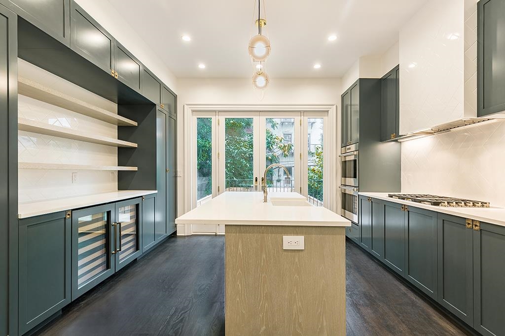 206 8th Street Hoboken, NJ 07030 - Photo 5 of 35 a kitchen with stainless steel appliances granite countertop a stove and a refrigerator