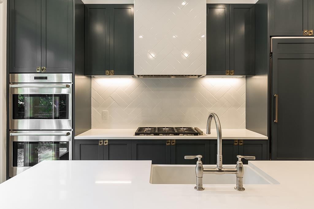 206 8th Street Hoboken, NJ 07030 - Photo 6 of 35 a kitchen with a sink cabinets and stainless steel appliances