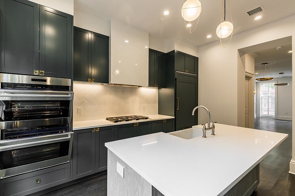 206 8th Street Hoboken, NJ 07030 - Photo 8 of 35 a kitchen with a stove a sink and a refrigerator
