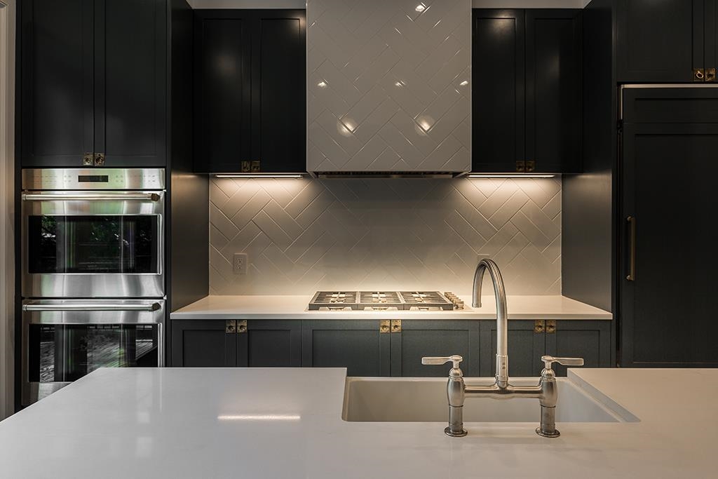 206 8th Street Hoboken, NJ 07030 - Photo 9 of 35 a kitchen with stainless steel appliances kitchen island granite countertop a refrigerator and a stove