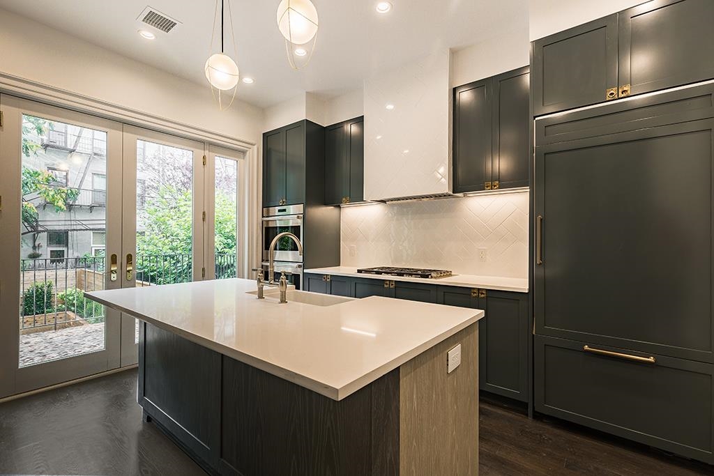 206 8th Street Hoboken, NJ 07030 - Photo 10 of 35 a kitchen with sink cabinets and wooden floor