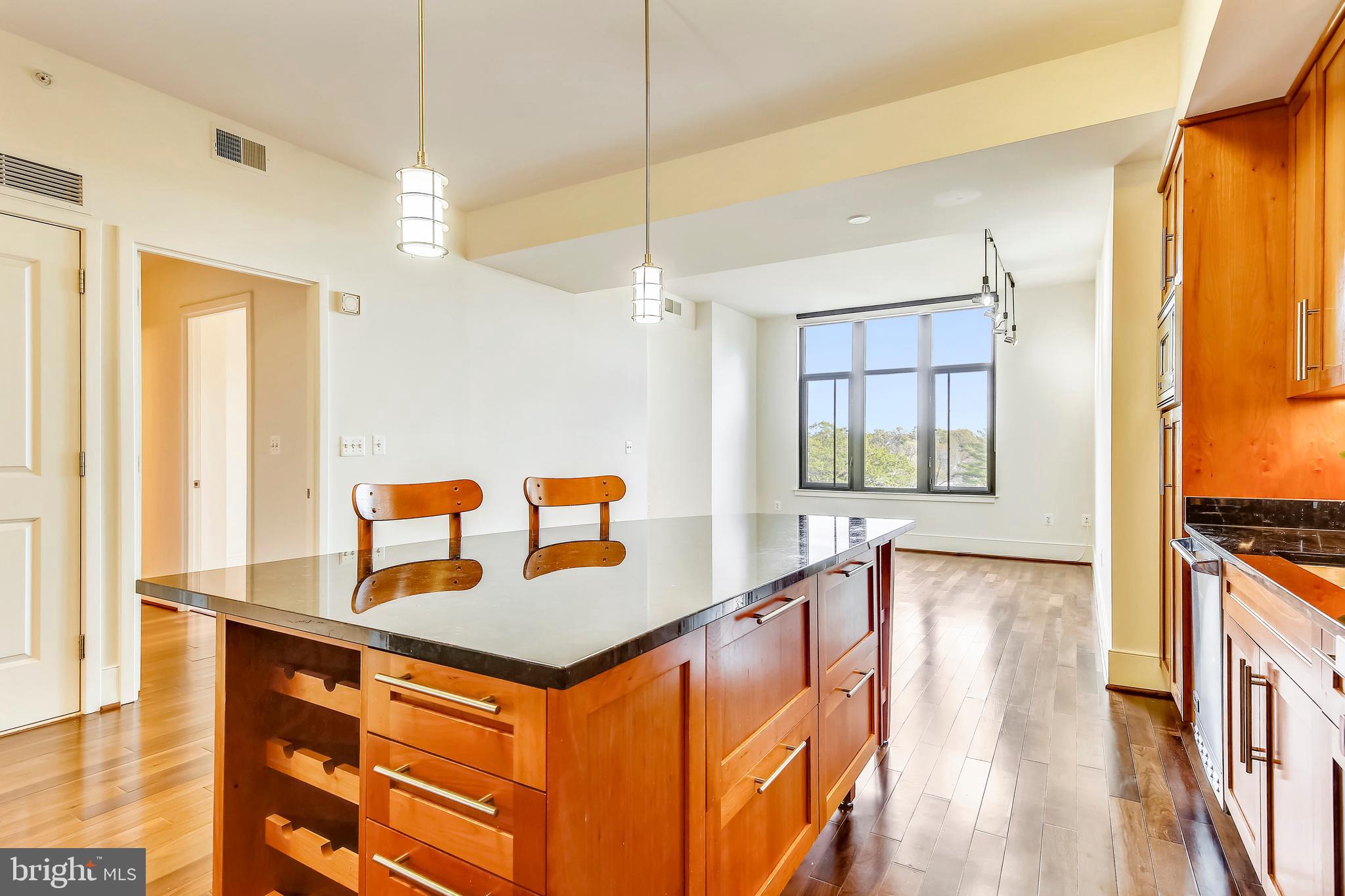 4301 Military Road Northwest, Unit PH5 Washington, DC 20015 - Photo 11 of 53 a view of a kitchen with kitchen island a large window a sink and a counter top space