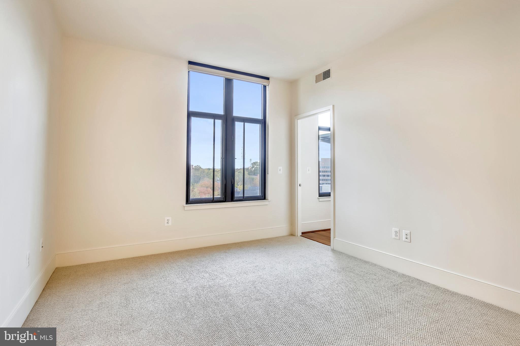 4301 Military Road Northwest, Unit PH5 Washington, DC 20015 - Photo 21 of 53 an empty room with windows and closet