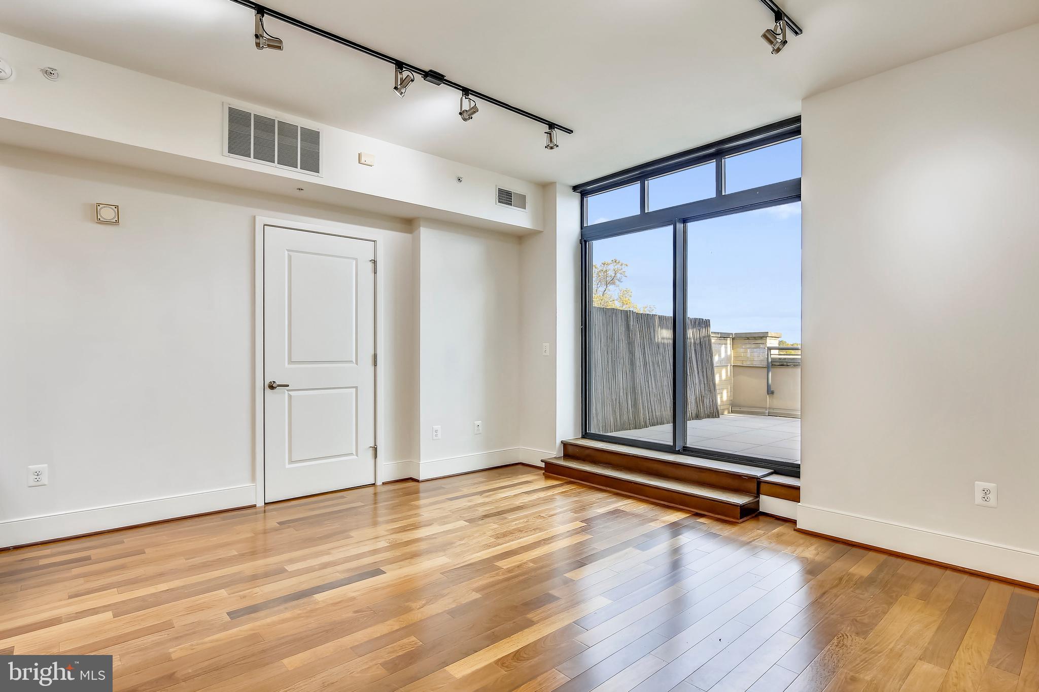 4301 Military Road Northwest, Unit PH5 Washington, DC 20015 - Photo 31 of 53 a view of room with wooden floor and window