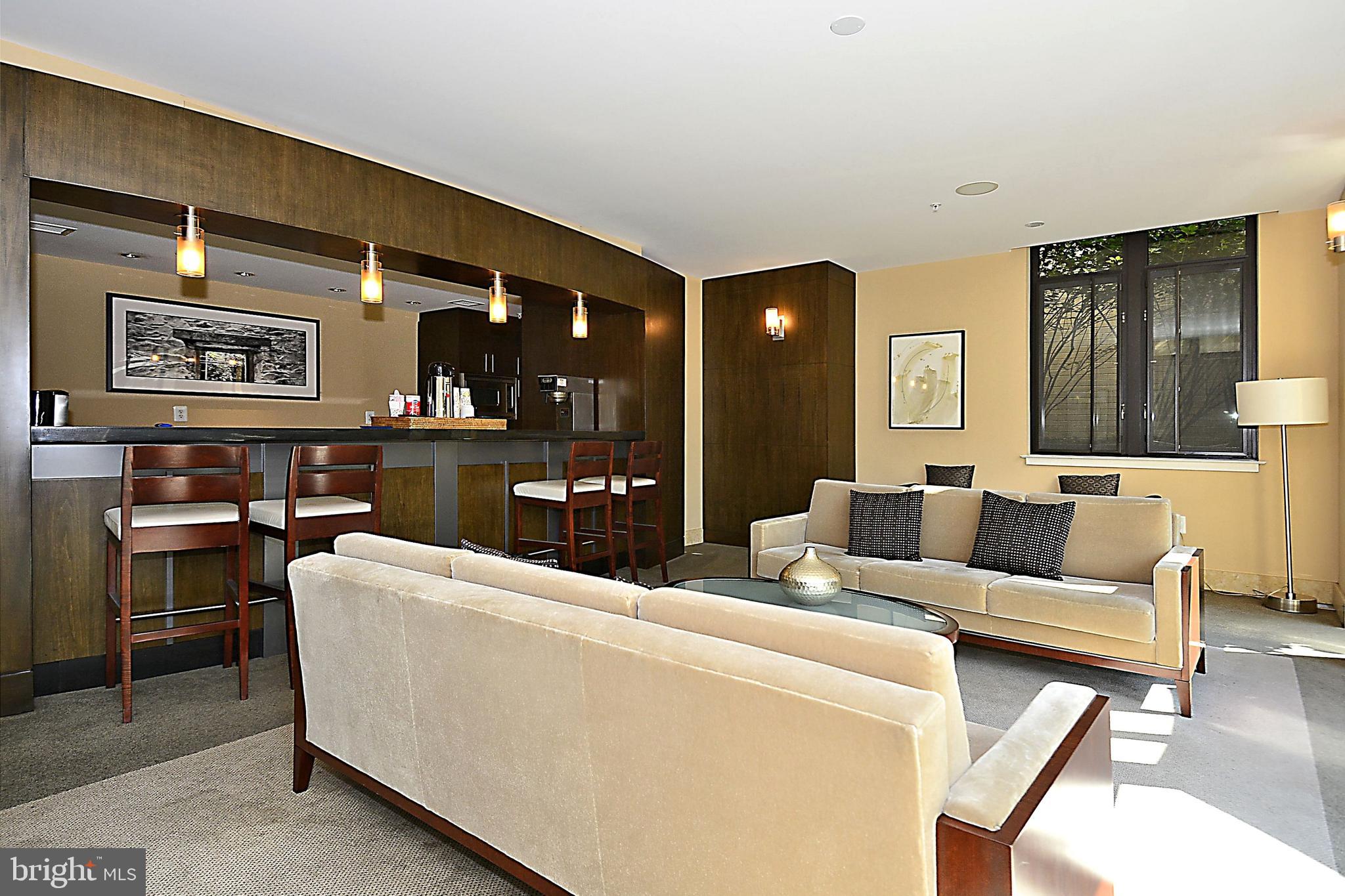 4301 Military Road Northwest, Unit PH5 Washington, DC 20015 - Photo 41 of 53 a living room with furniture a lamp and kitchen view