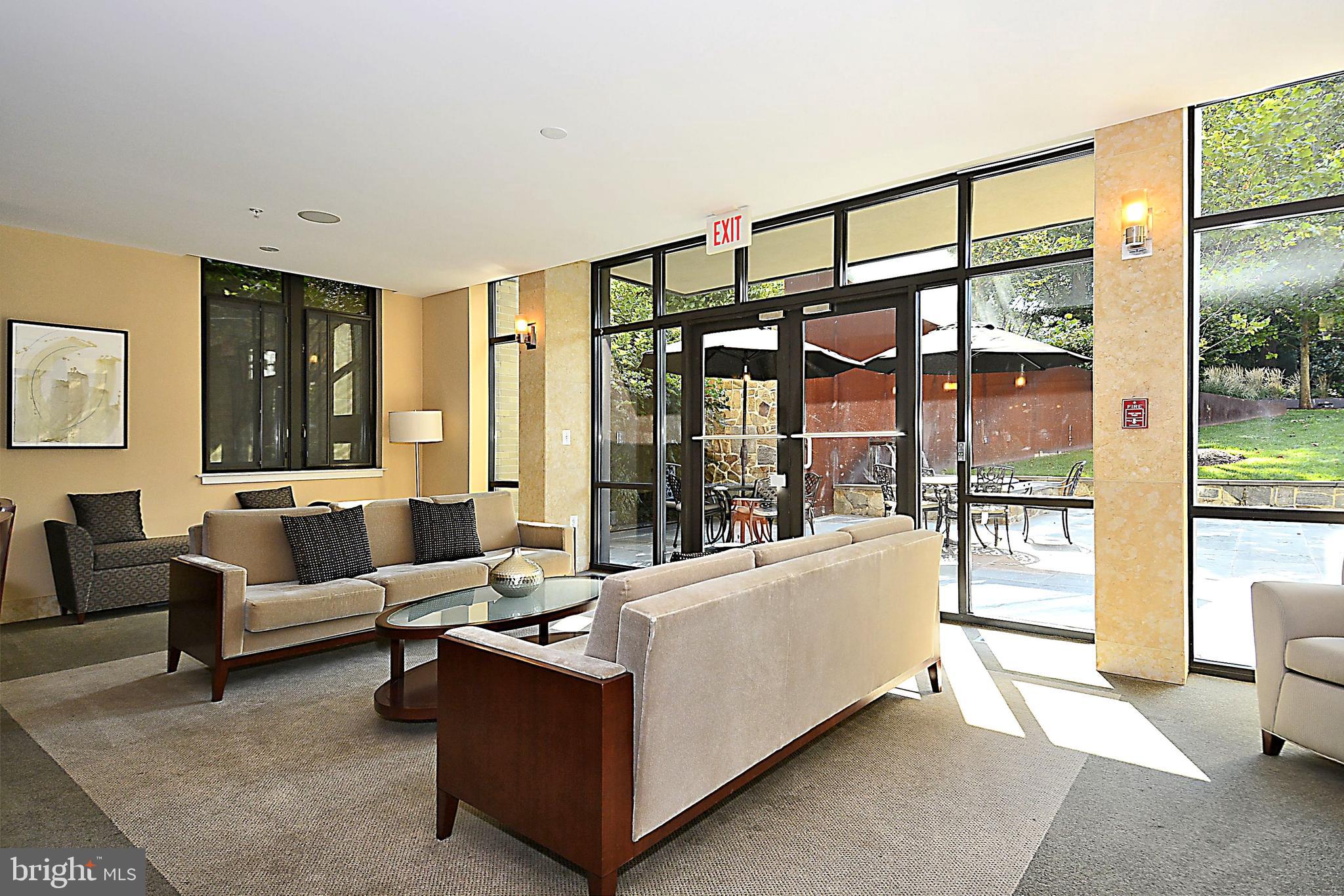 4301 Military Road Northwest, Unit PH5 Washington, DC 20015 - Photo 42 of 53 a living room with furniture and a large window
