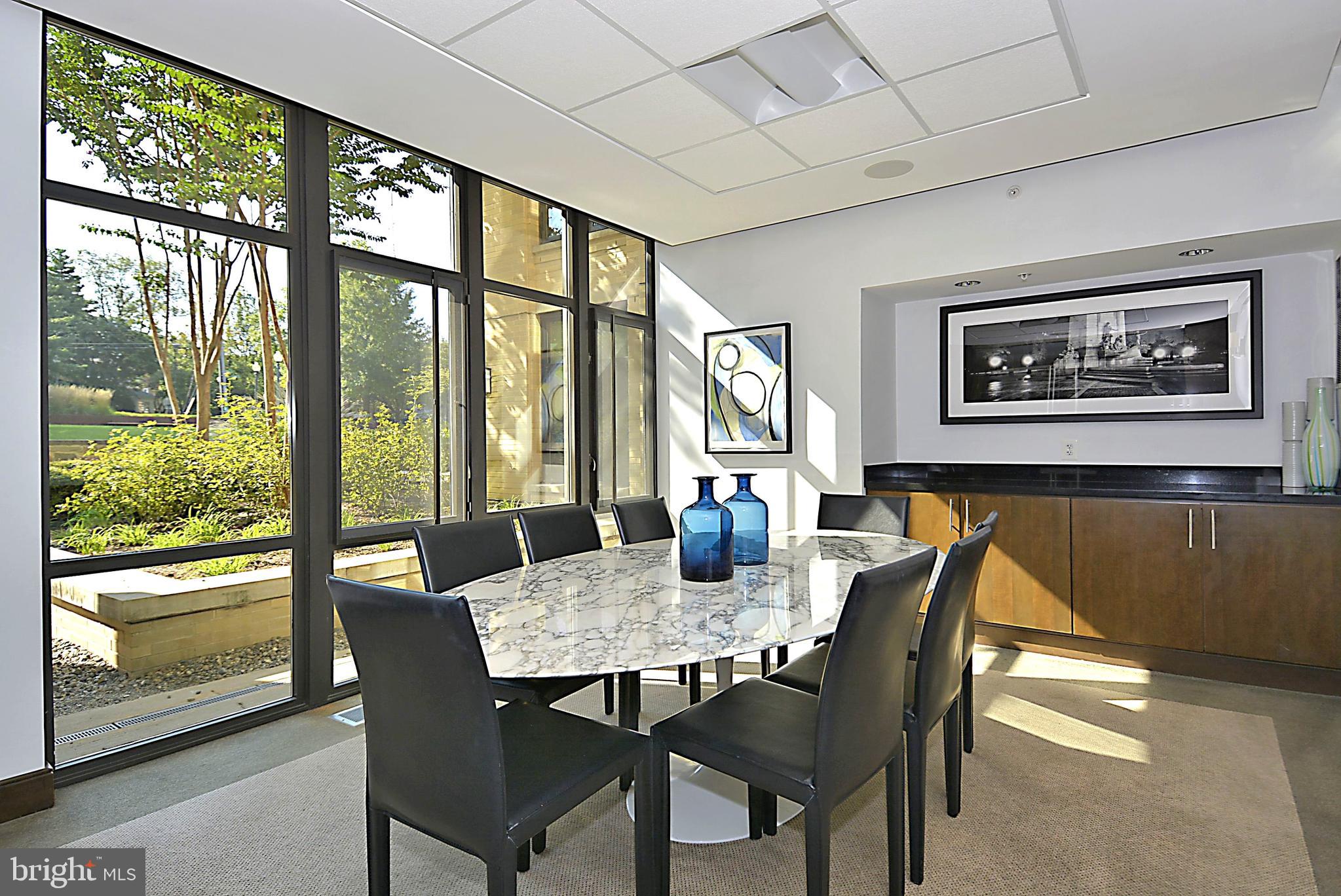 4301 Military Road Northwest, Unit PH5 Washington, DC 20015 - Photo 46 of 53 a view of a dining room with furniture large window and outside view