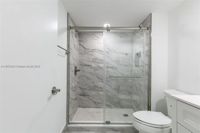 a bathroom with a shower and a toilet