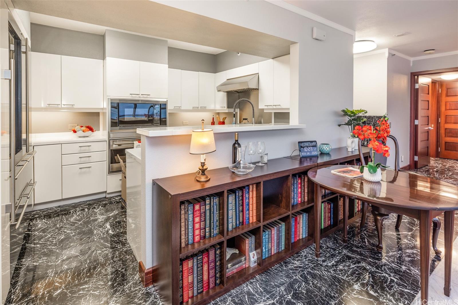 415 South Street, Unit 4202 Honolulu, HI 96813 - Photo 11 of 21 a room with stainless steel appliances kitchen island granite countertop a table chairs in it and a window