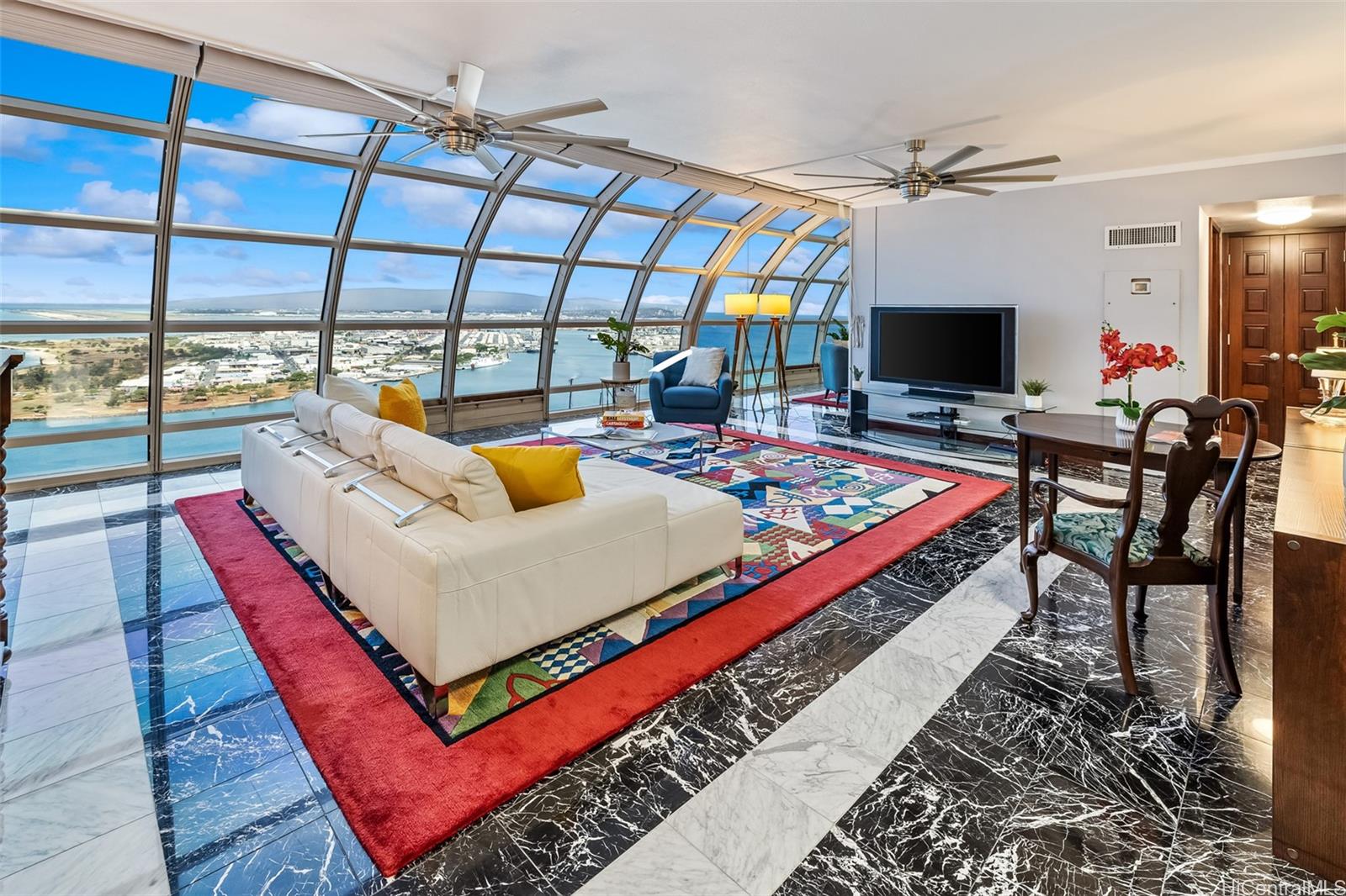 415 South Street, Unit 4202 Honolulu, HI 96813 - Photo 4 of 21 a living room with furniture a flat screen tv and a floor to ceiling window