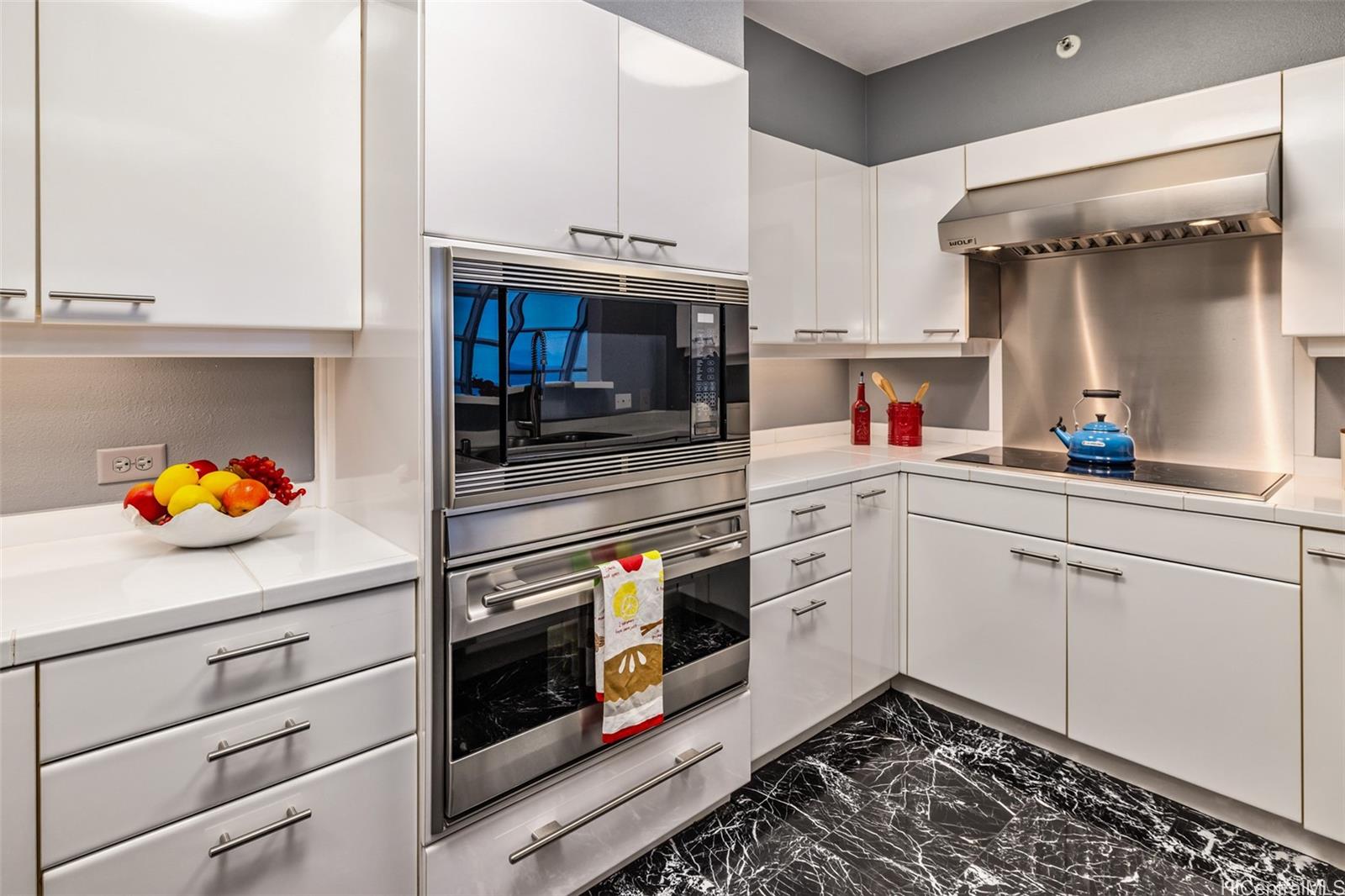 415 South Street, Unit 4202 Honolulu, HI 96813 - Photo 9 of 21 a kitchen with stainless steel appliances a stove and cabinets