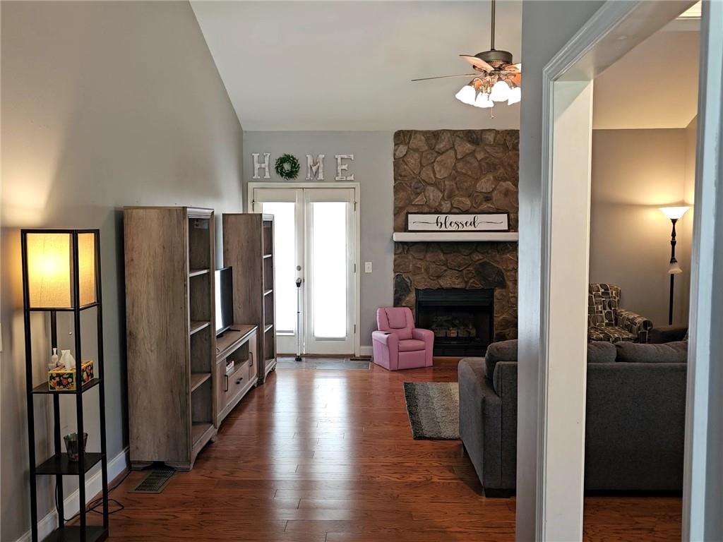 147 Crest Winds Drive Clarkesville, GA 30523 - Photo 5 of 17 a living room with furniture wooden floor and a fireplace