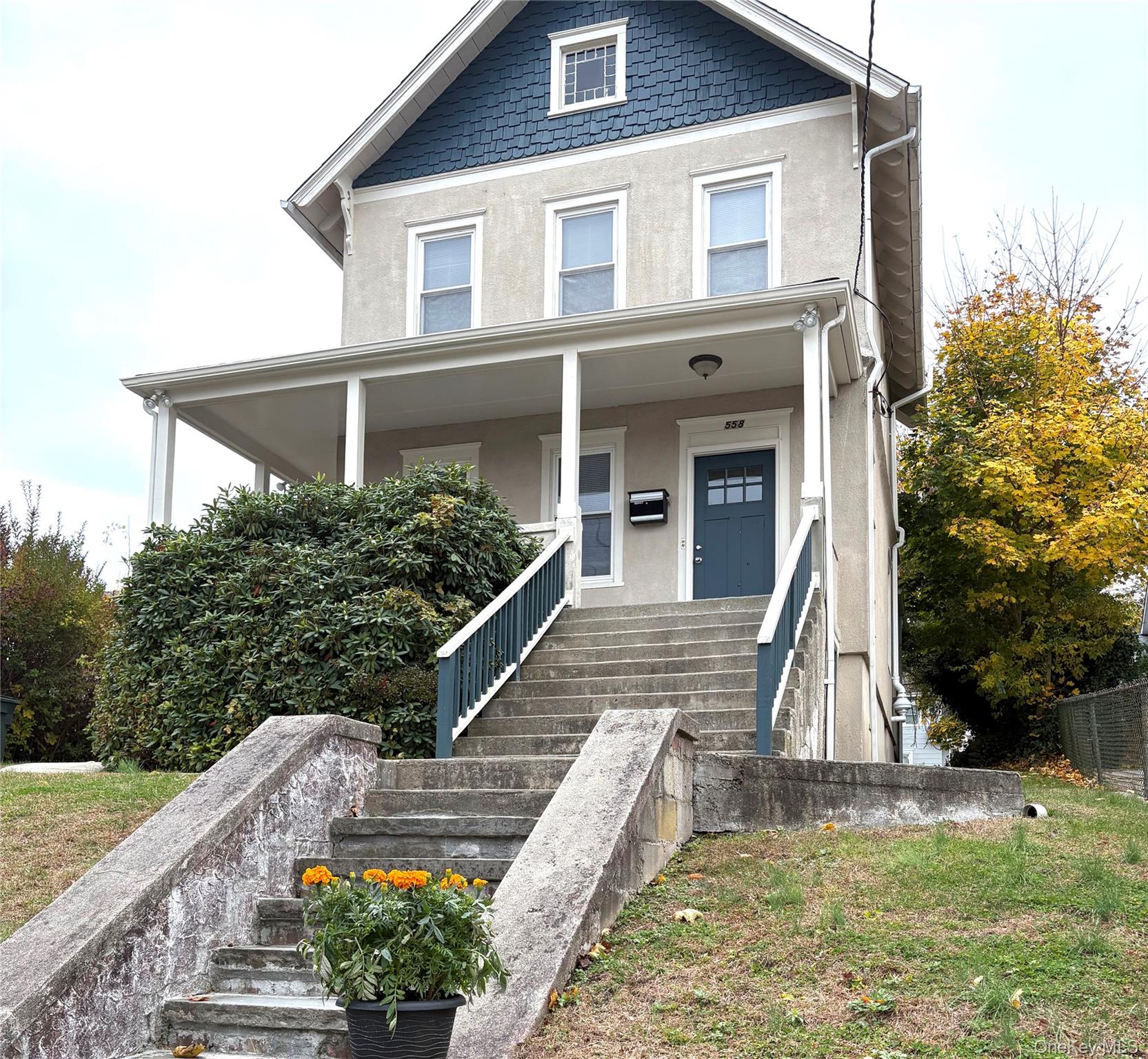 a front view of house with sign board and yard