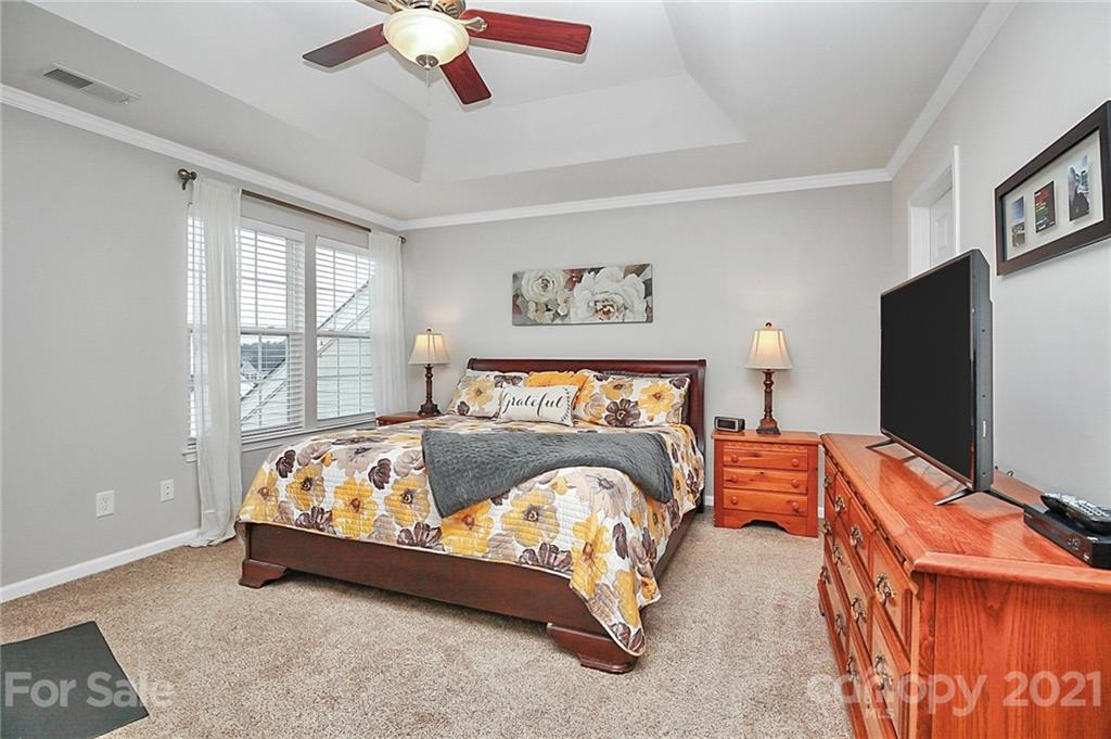 417 Windsor Gate Drive Fort Mill, SC 29708 - Photo 22 of 37 a bedroom with bed and a flat tv screen on dresser