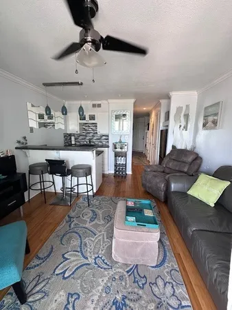 a living room with lots of furniture and kitchen view
