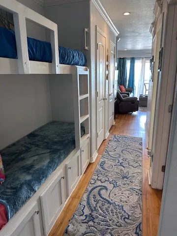 a view of a hallway with wooden floor and staircase