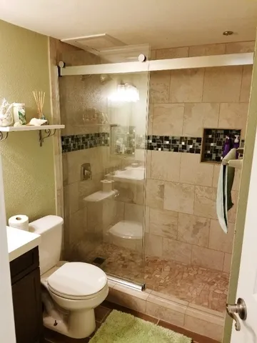 a bathroom with a shower and a toilet