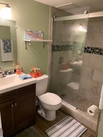 a bathroom with a sink toilet and shower