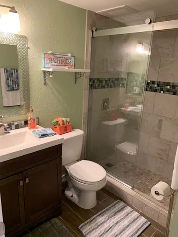 a bathroom with a sink toilet and shower
