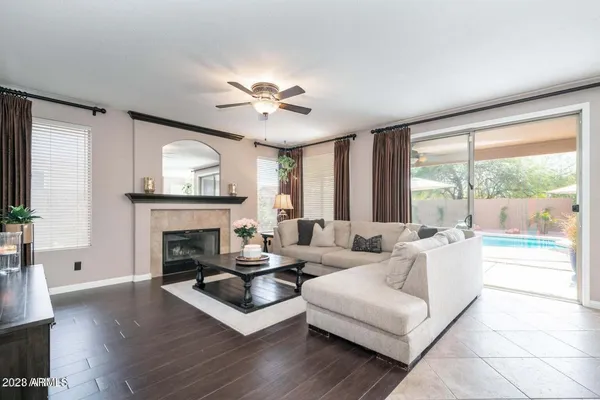 a living room with furniture a fireplace and a large window