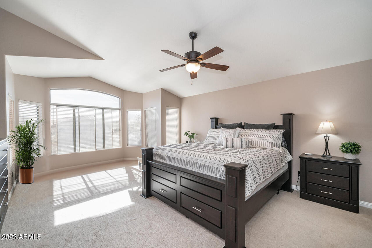 4621 East Kirkland Road Phoenix, AZ 85050 - Photo 18 of 32 a spacious bedroom with a bed and a large window