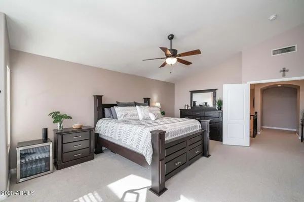 a bedroom with a bed and a chandelier