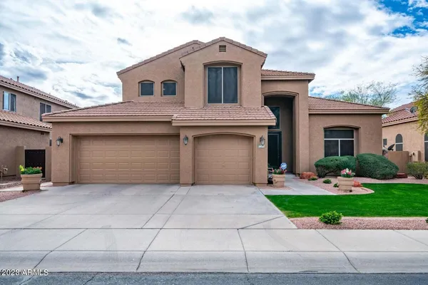 a front view of a house with a yard and garage