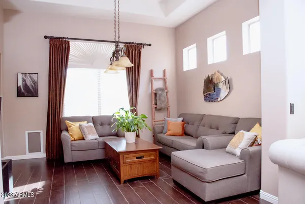 a living room with furniture and a potted plant