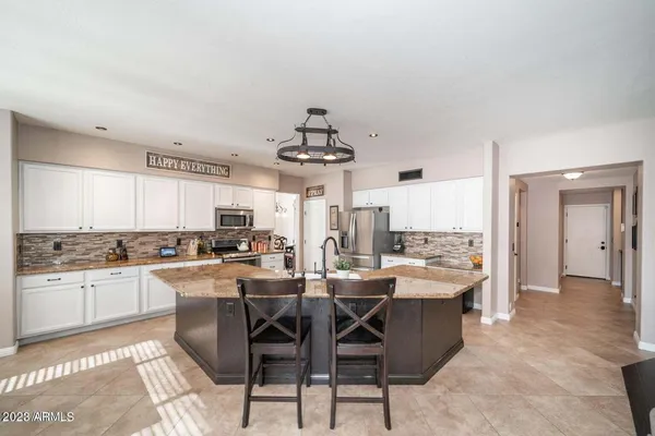 a large kitchen with a table and chairs in it