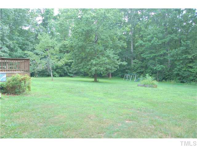 514 Dick Holeman Road Timberlake, NC 27583 - Photo 16 of 21 a view of a green field with trees in the background