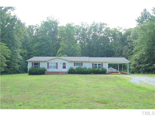 514 Dick Holeman Road Timberlake, NC 27583 - Photo 20 of 21 a view of a house next to a big yard and large trees
