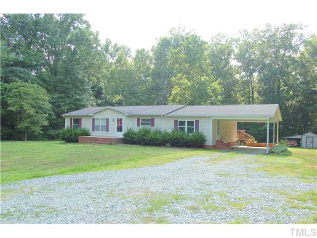 514 Dick Holeman Road Timberlake, NC 27583 - Photo 21 of 21 a view of a yard in front of a house with a garden and trees