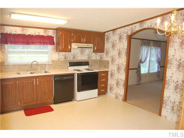 514 Dick Holeman Road Timberlake, NC 27583 - Photo 3 of 21 a kitchen with stainless steel appliances a sink and a refrigerator