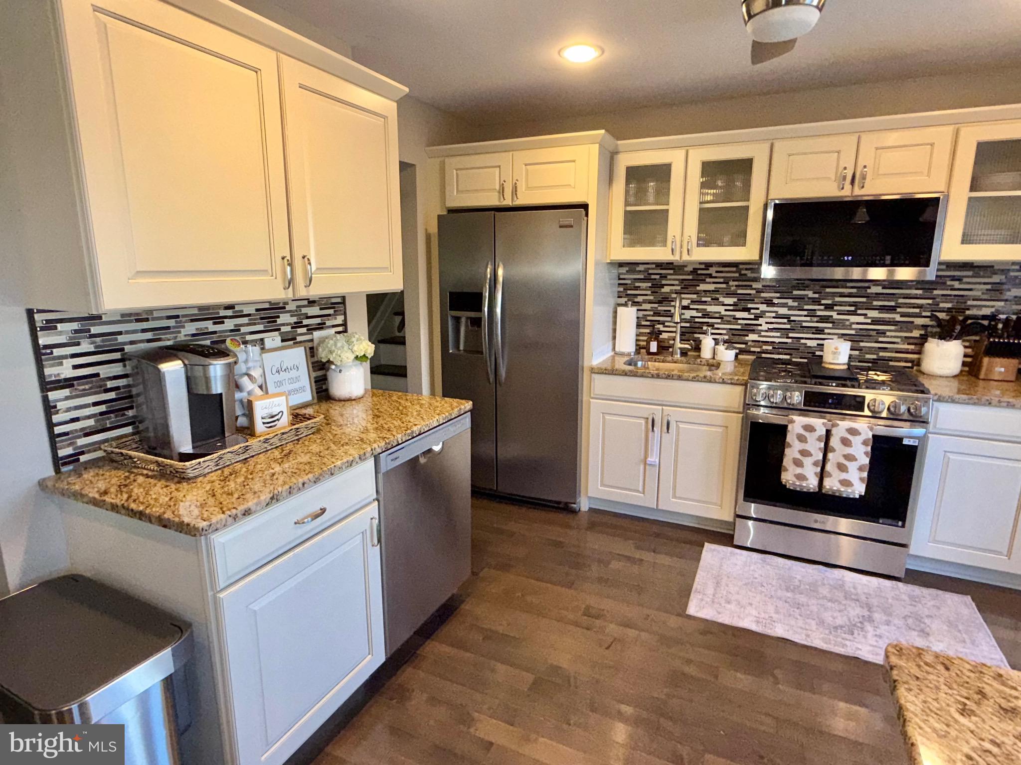 30 Rock Royal Road Hamilton, NJ 08620 - Photo 29 of 54 a kitchen with stainless steel appliances granite countertop a stove a sink and a microwave