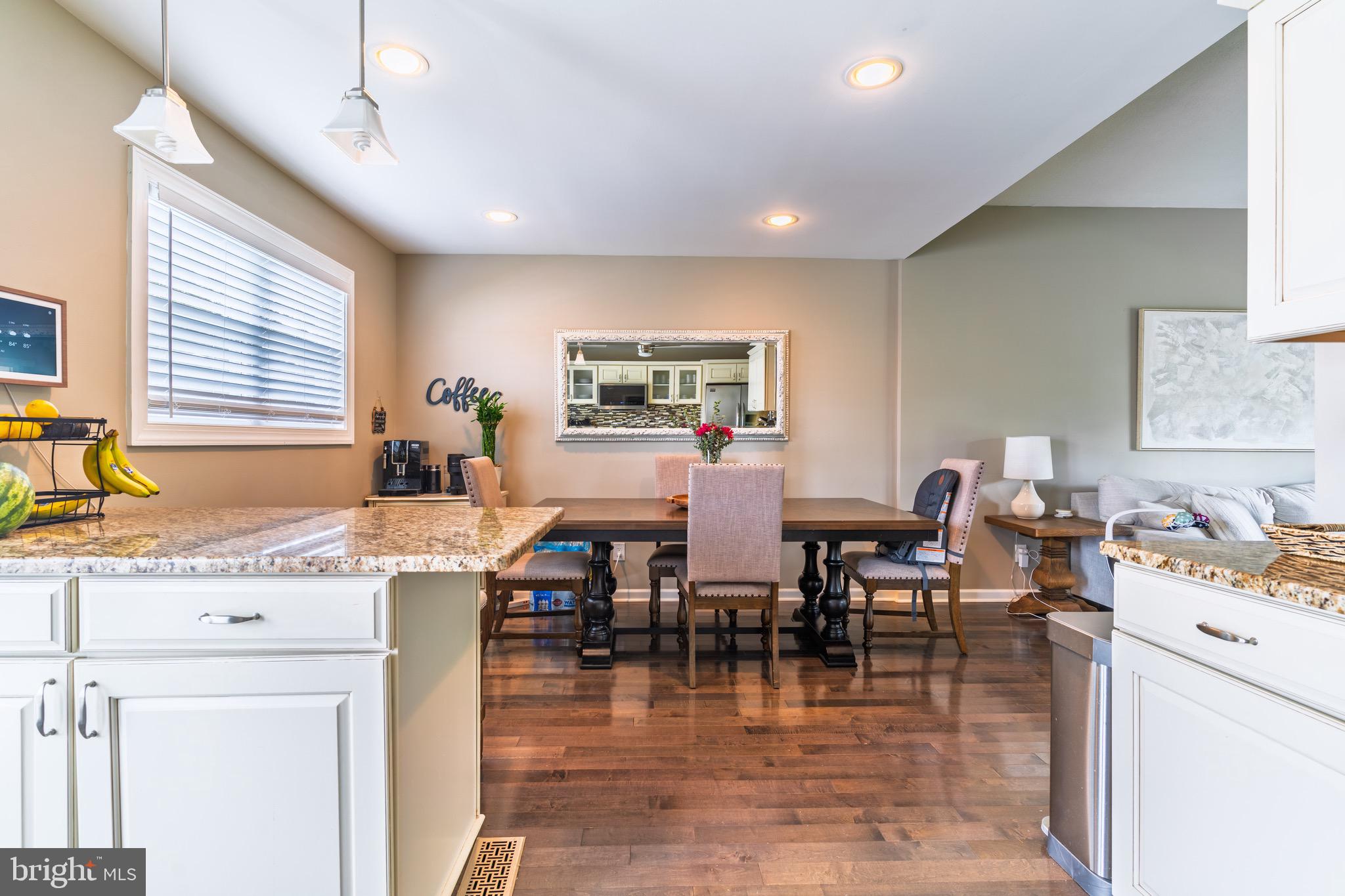 30 Rock Royal Road Hamilton, NJ 08620 - Photo 35 of 54 a open kitchen with stainless steel appliances granite countertop a stove top oven a dining table and chairs with wooden floor