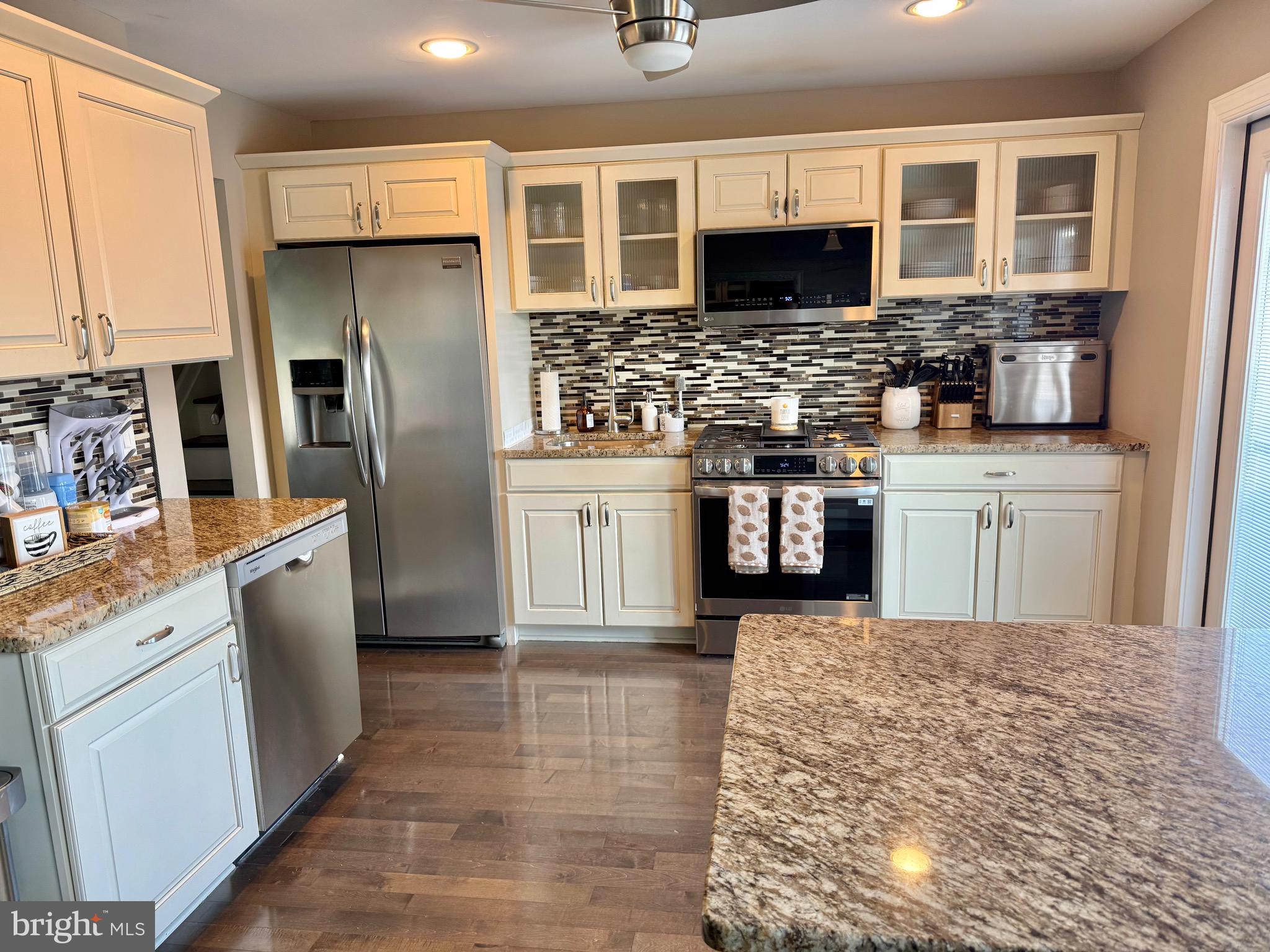 30 Rock Royal Road Hamilton, NJ 08620 - Photo 36 of 54 a kitchen with stainless steel appliances kitchen island granite countertop a refrigerator a stove top oven a sink and dishwasher