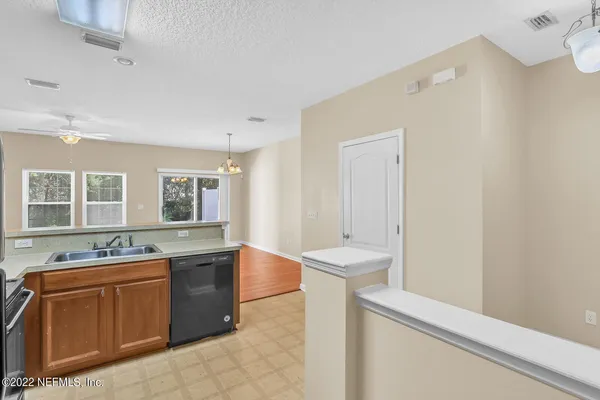 a view of a kitchen with a sink and wooden floor