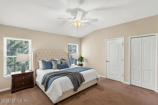 a bedroom with a bed and window