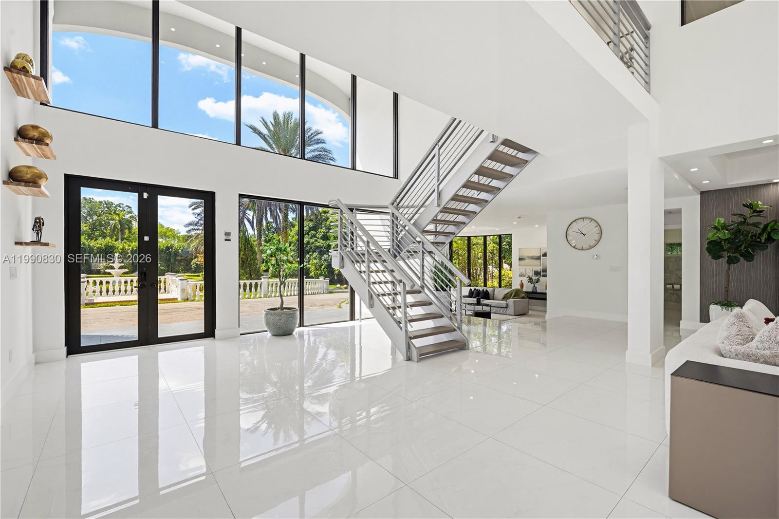 a view of living room filled with furniture and large window