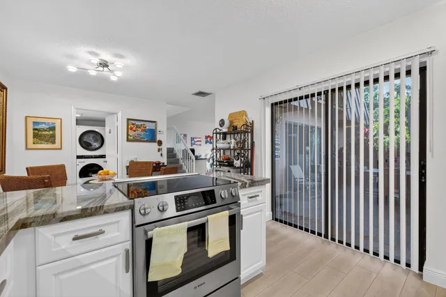 a kitchen with stainless steel appliances granite countertop a stove and a refrigerator