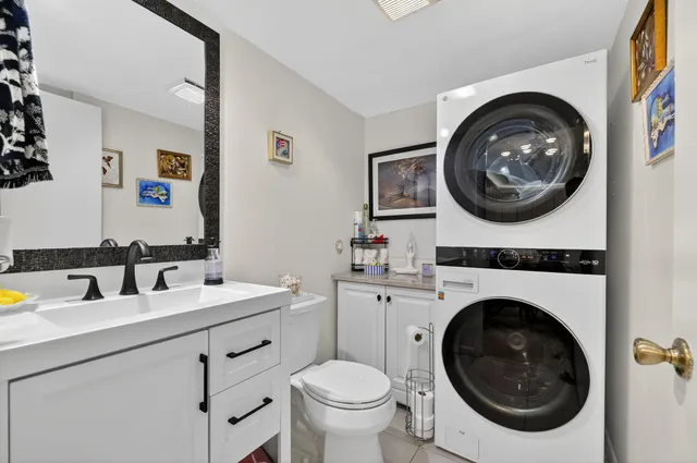 a bathroom with a toilet a sink and a mirror