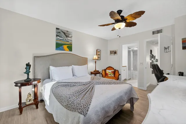 a bedroom with bed and a chandelier