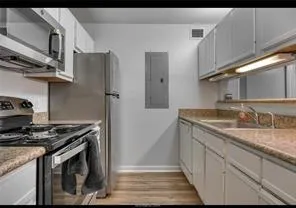 a stove top oven sitting inside of a kitchen